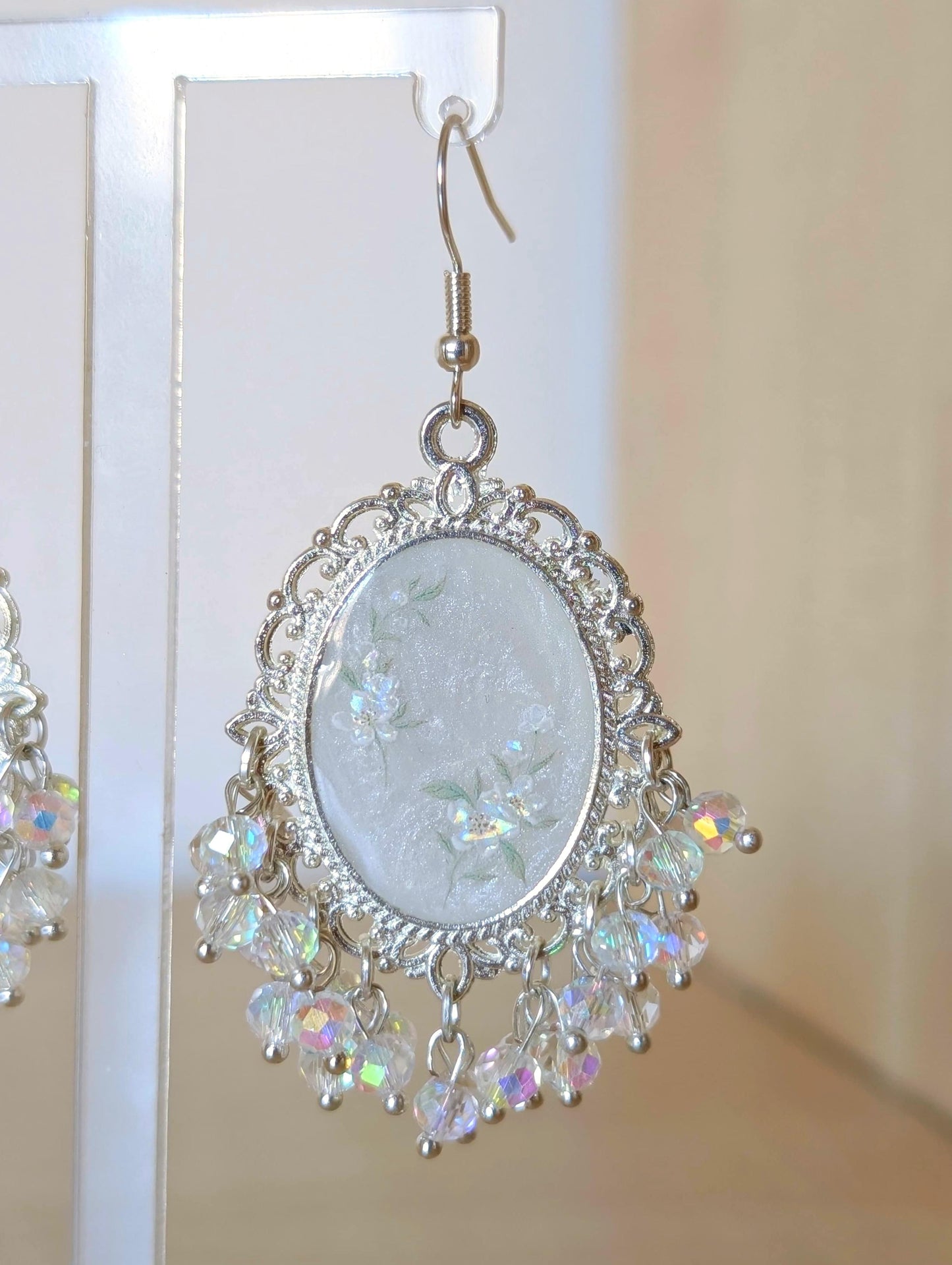White floral resin earrings in silver
