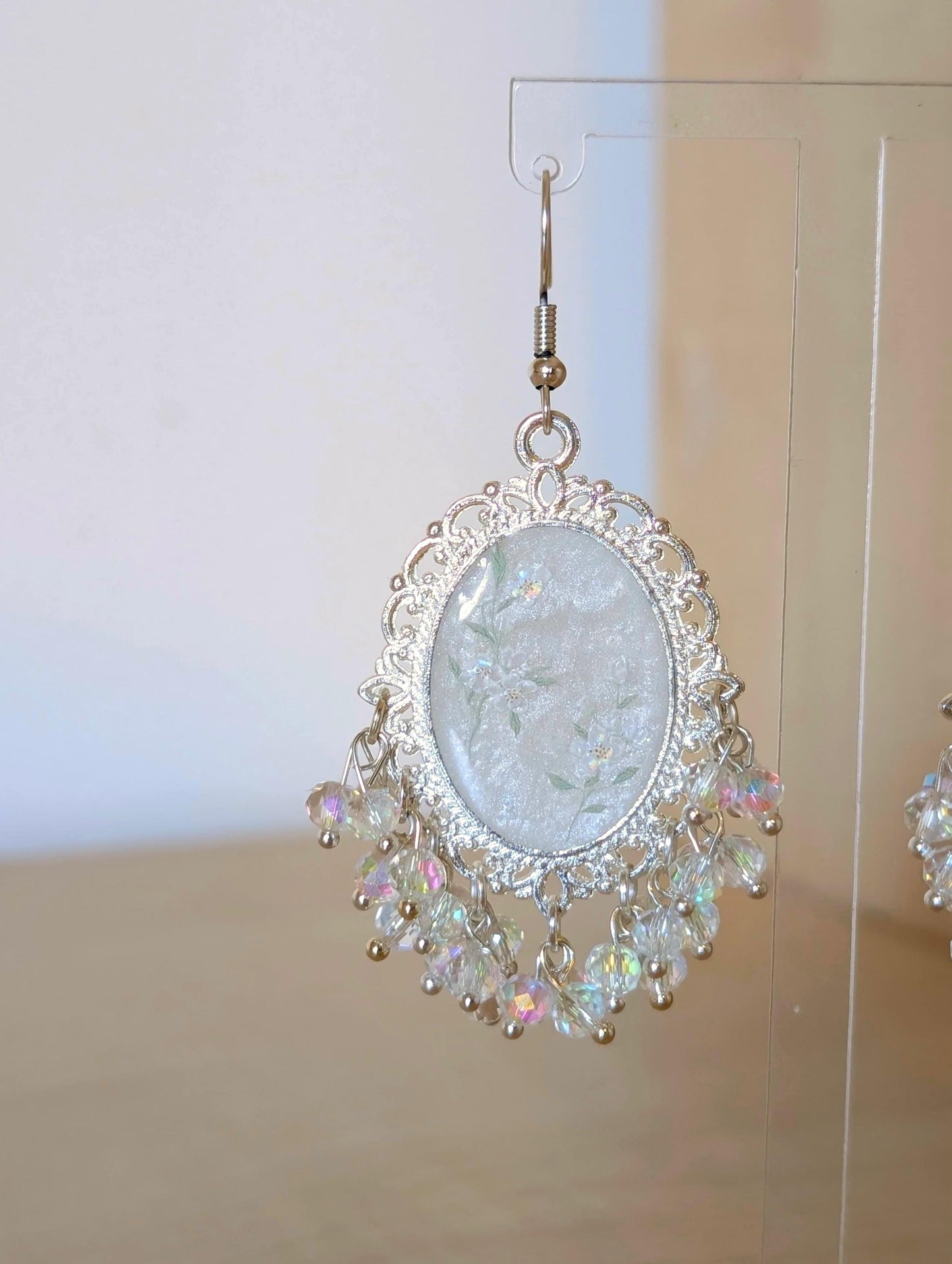 White floral resin earrings in silver
