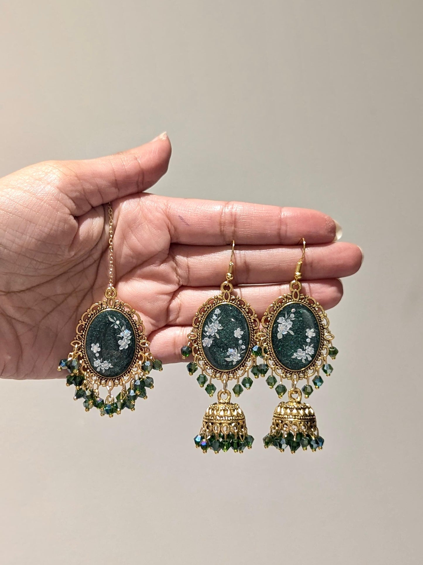 Green jhumka tikka set in gold bronze